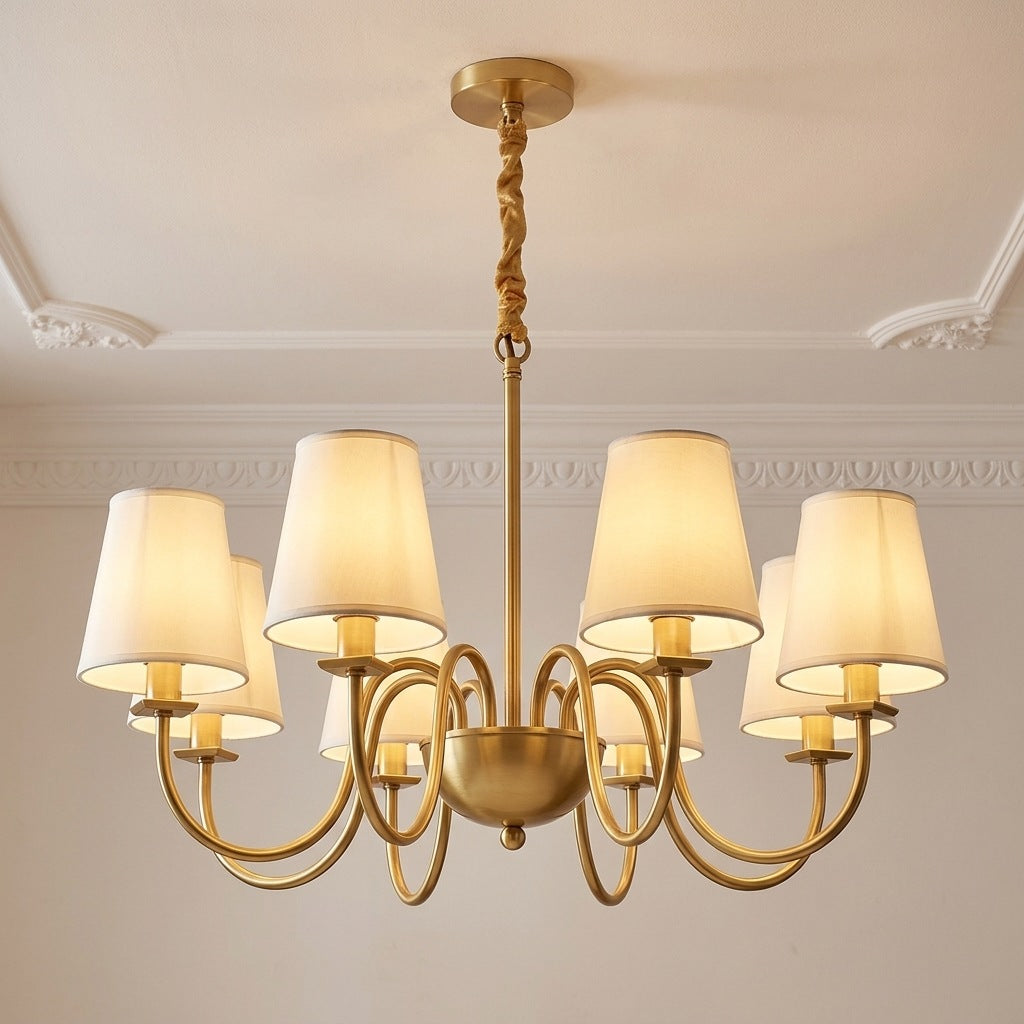 Vintage brass chandelier with 8 ivory fabric shades lit on a moulded ceiling, 28.7 inches across