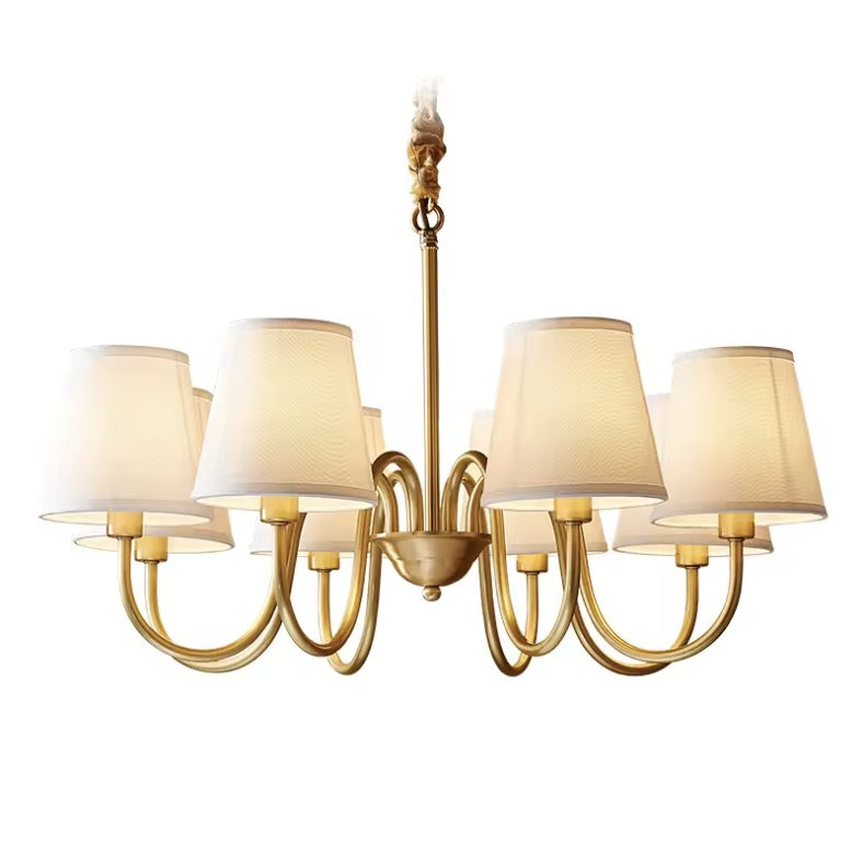 Vintage brass chandelier with eight curved arms and tapered fabric shades Image