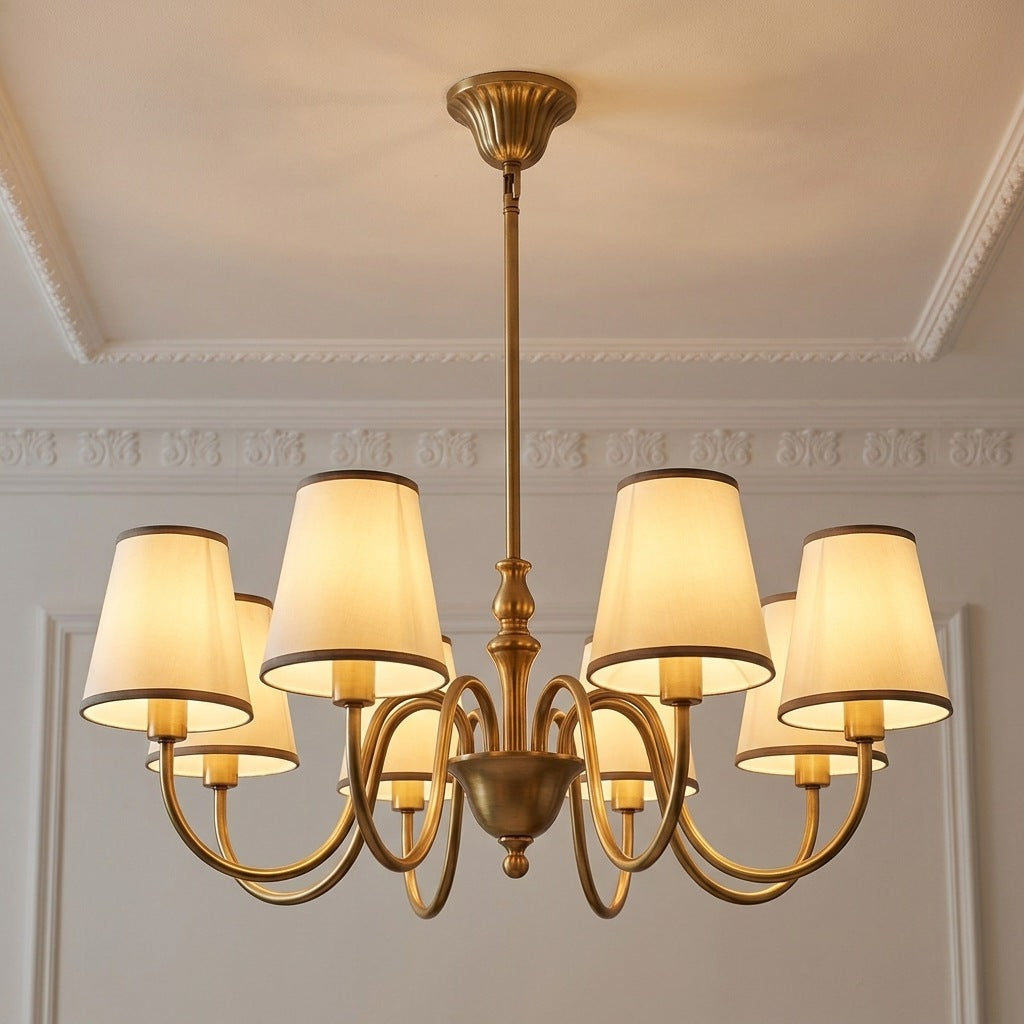Vintage brass chandelier with 8 ivory fabric shades lit on a moulded ceiling, 28.7 inches across