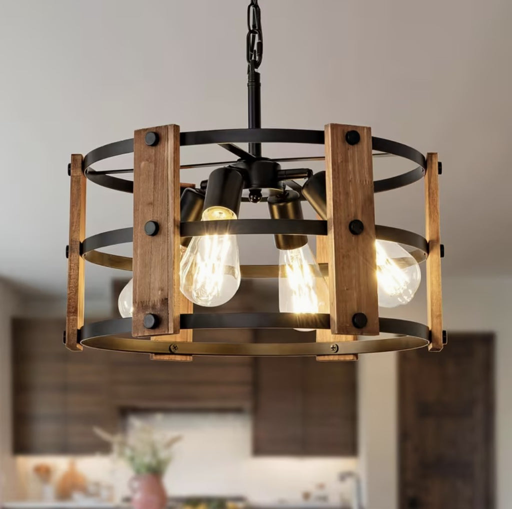 Vintage farmhouse chandelier in walnut and black metal, lit above a kitchen