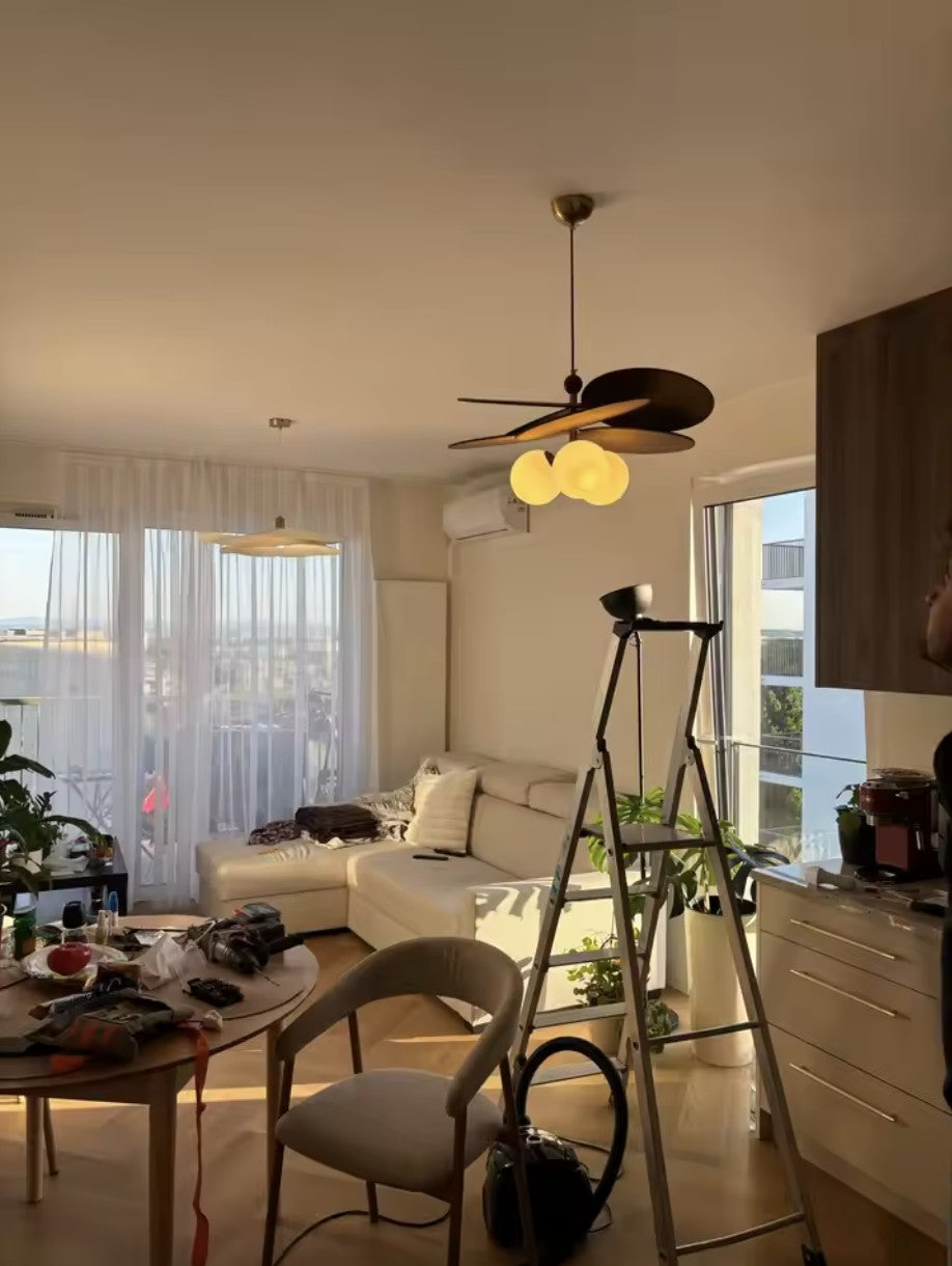 Customer photo, walnut disc pendant light lit in a living room