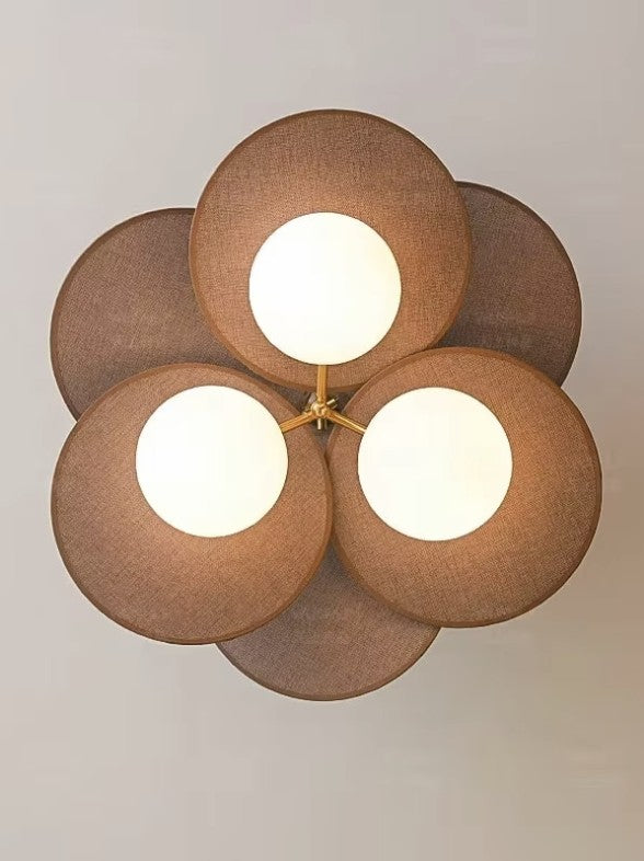 Walnut disc pendant light seen from below, three opal globes