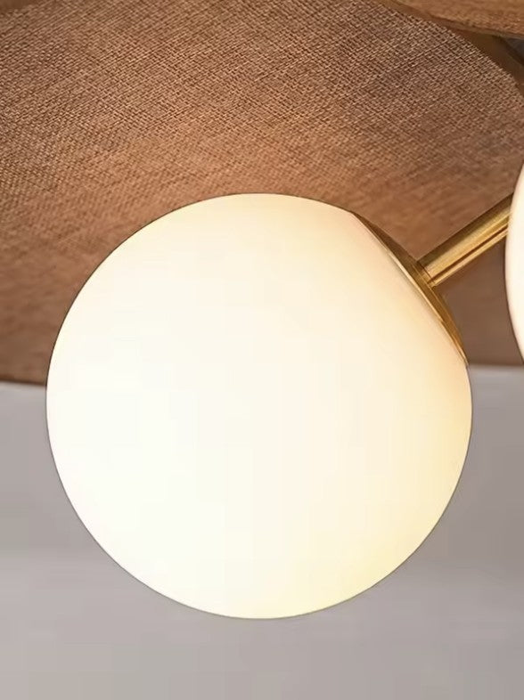 Close up of the opal glass globe and the brass arm