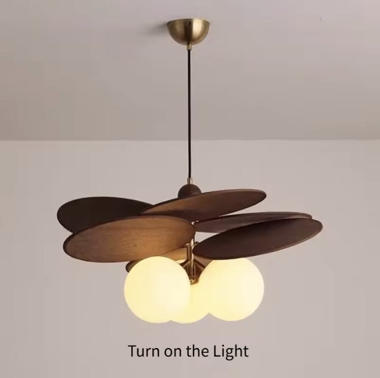 Walnut disc pendant light switched on