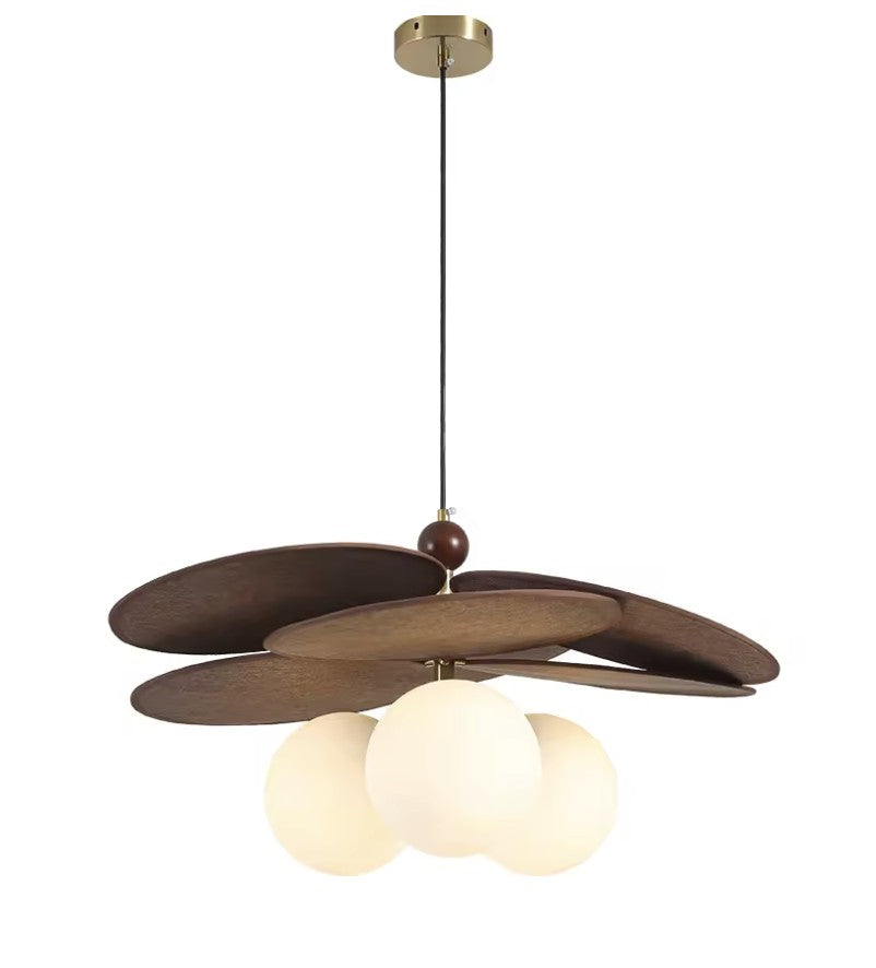 Walnut disc pendant light with three opal glass globes, studio view